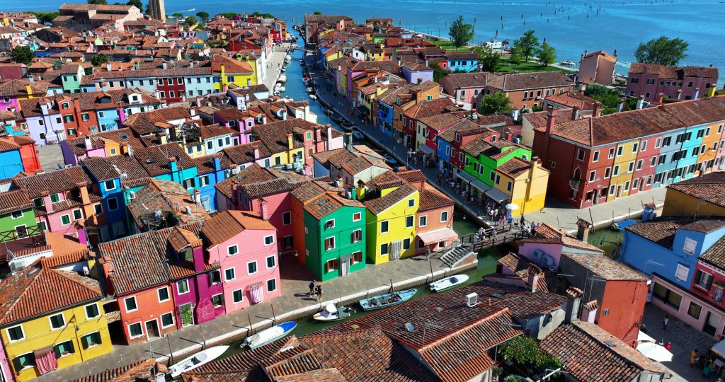 Vibrant facades of Burano, scenic canals and fishing town charm near Venice